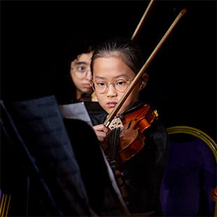Young student learning piano with teacher - Nord Anglia Education